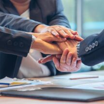 Hände von Teammitgliedern aufeinandergelegt | Büroreinigung in Düsseldorf